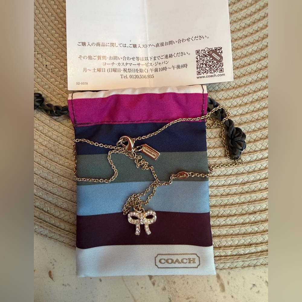 Coach Gold-Tone Crystal Bow Necklace with Legacy Striped Pouch and Coach Logo - Picture 4 of 7